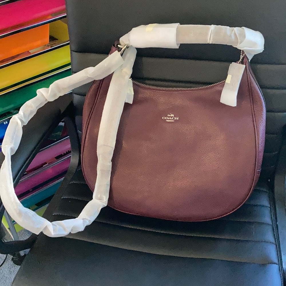 A burgundy coach bag